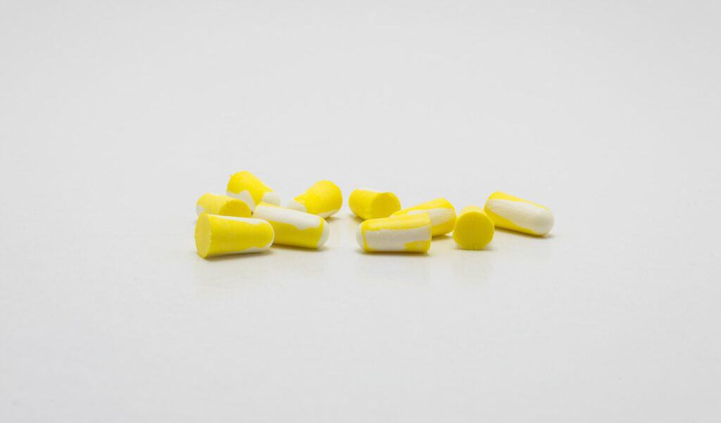 Ear plugs for protection against noise in yellow and white